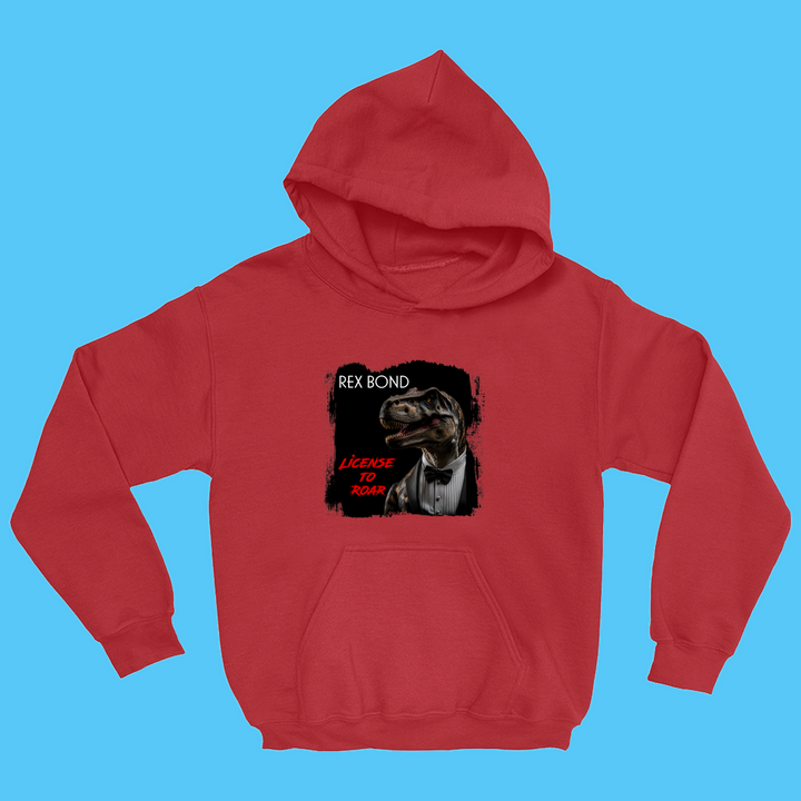 The Kids Rex Bond Hoodie by Jurassic Studio showcases a tuxedo-wearing dinosaur in a movie poster style with REX BOND and LICENSE TO ROAR text. Displayed on a blue backdrop, this red hoodie is perfect for young dinosaur fans!.