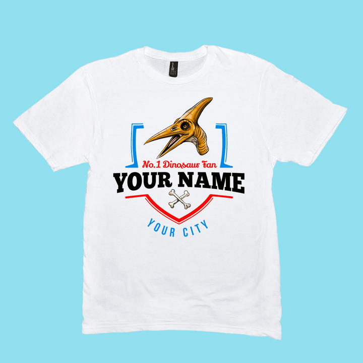 Jurassic Studio’s N.1 Pterodactyl Fan Custom Men T-Shirt features a cartoon pterosaur head, red No.1 Dinosaur Fan, crossed bones, and your personalized name and city—a unique gift for dino lovers!.