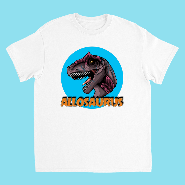Jurassic Studio’s Kids Allosaurus Head T-Shirt showcases a fierce Allosaurus head in a blue circle above bold, orange text. This exclusive tee, set on a light blue background, is the perfect dinosaur fan gift!.