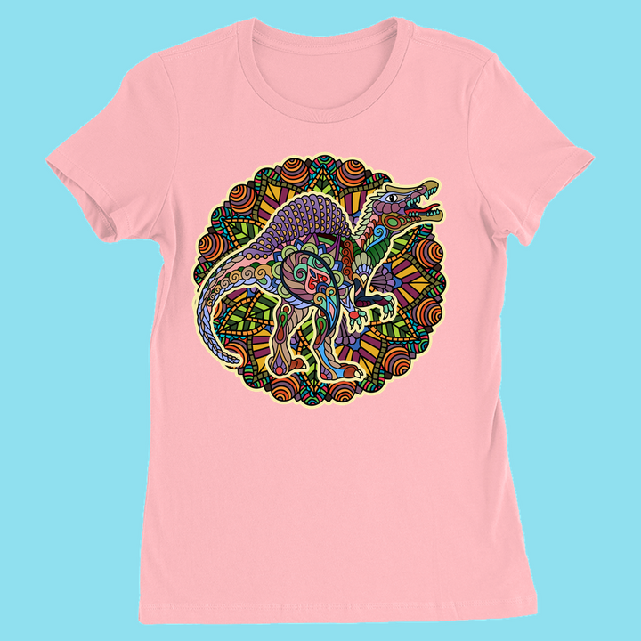 The Women Spinosaurus Mandala T-Shirt by Jurassic Studio features a pink tee with a vibrant, mandala-style dinosaur design framed by geometric swirls—ideal for any dino fan. Shown on a light blue backdrop.