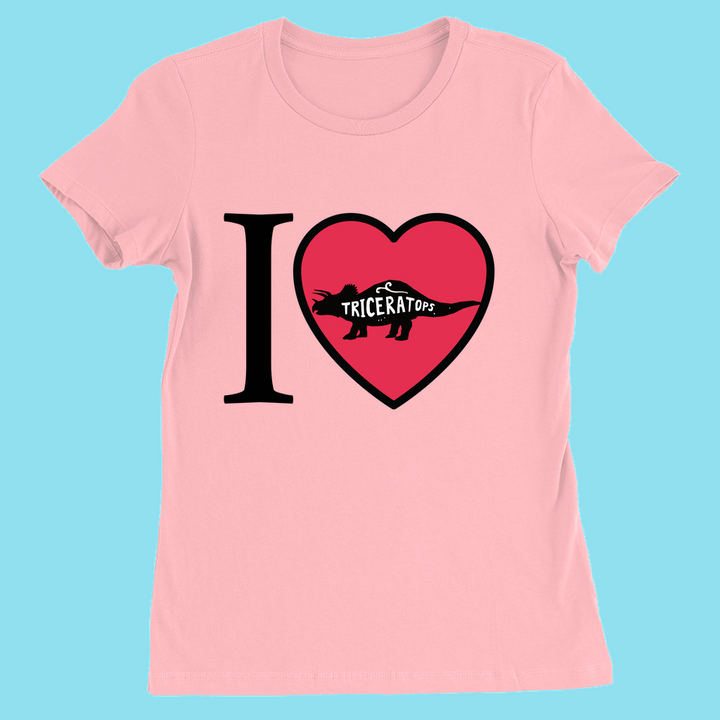 The Women I Love Triceratops T-Shirt by Jurassic Studio features a pink design with a heart, Triceratops silhouette, and the word “Triceratops”—a perfect dinosaur gift. Displayed on a light blue background.