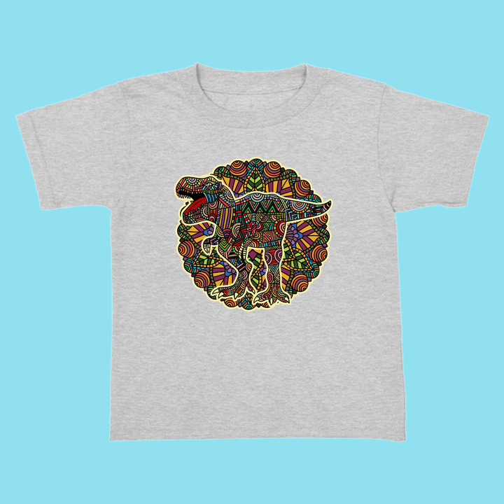 The Jurassic Studio Toddler T-Rex Mandala T-Shirt is a gray, 100% cotton tee with a colorful circular dinosaur design featuring geometric and tribal patterns—an ideal gift for young dino fans.