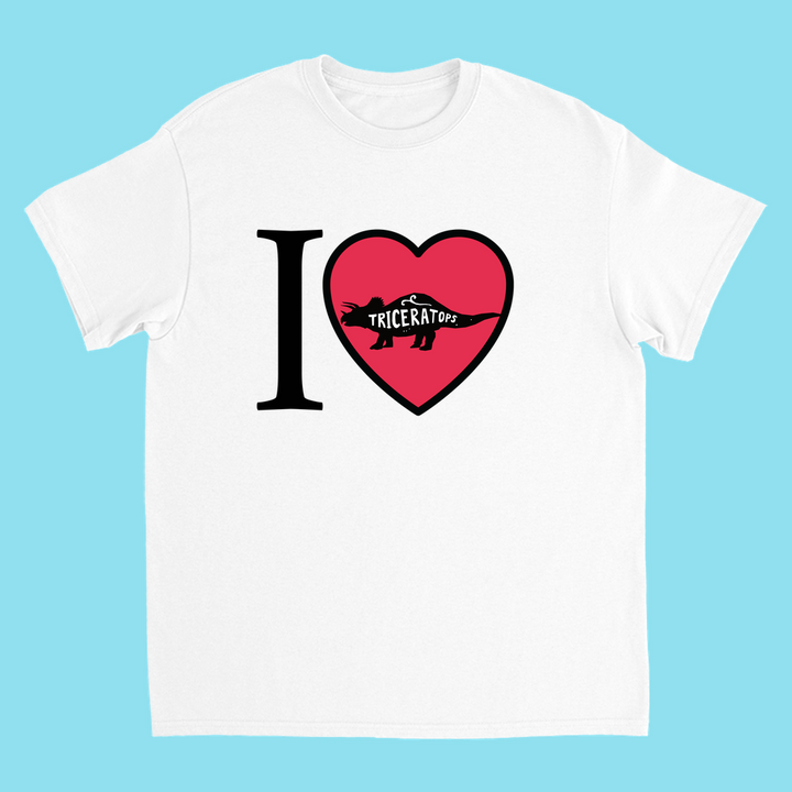 Jurassic Studio Kids I Love Triceratops T-Shirt—white tee with big I, red heart and Triceratops silhouette, plus Triceratops on the dino. Blue background. Great gift for dinosaur fans!.