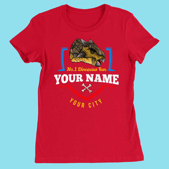 Red women’s Jurassic Studio “N.1 Ankylosaurus Fan” T-shirt with a customizable name and city, ankylosaurus head above the text, and two crossed bones below—the perfect personalized dinosaur shirt.