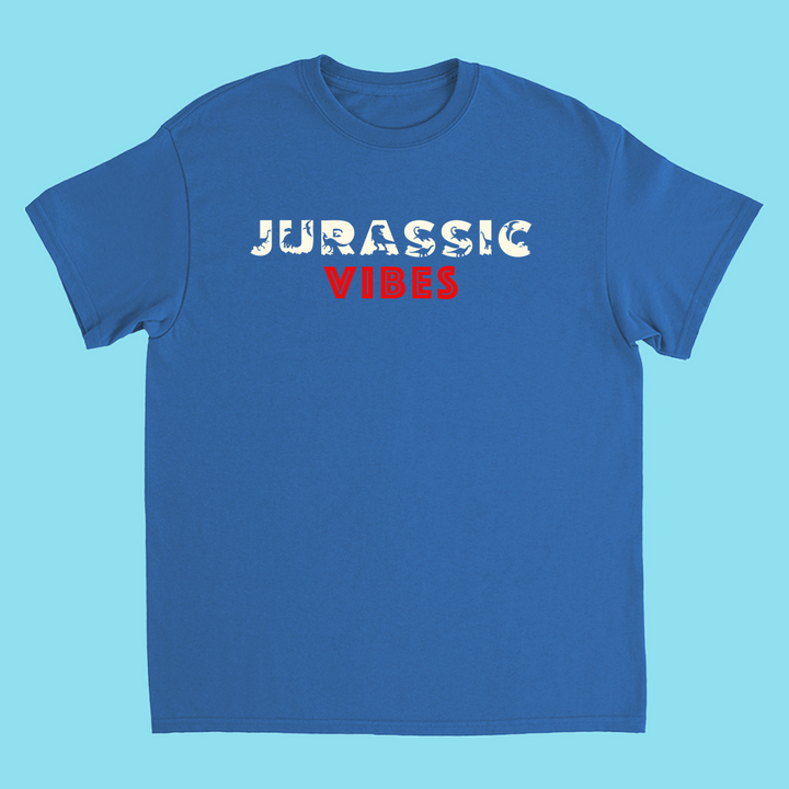 The Kids Jurassic Vibes T-Shirt by Jurassic Studio features JURASSIC in cracked white and VIBES in bold red on the front. Made of 100% cotton, its a perfect gift for dinosaur fans.