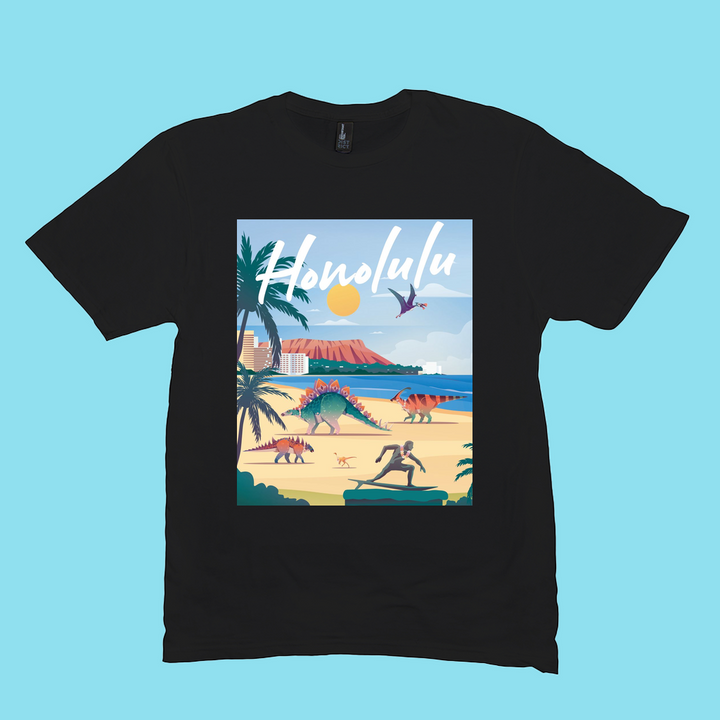 The Men Honolulu T-Shirt by Jurassic Studio is a black 100% cotton shirt with an illustrated beach scene of dinosaurs, palm trees, and a volcano. Honolulu in bold white script makes it the perfect gift for dinosaur fans!.