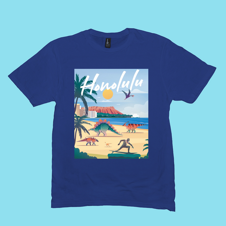The Men Honolulu T-Shirt by Jurassic Studio features an illustrated beach scene with dinosaurs, palm trees, ocean, and mountains. “Honolulu” appears in bold white script on a light blue background—an ideal gift for dinosaur fans. 100% cotton.