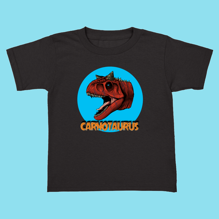 The Toddler Carnotaurus Head T-Shirt by Jurassic Studio features a cartoon red Carnotaurus in a blue circle with bold CARNOTAURUS lettering—an exclusive dinosaur fan gift and perfect addition to any toddler collection.