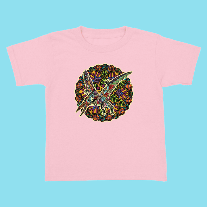 The Toddler Pterodactyl Mandala T-Shirt by Jurassic Studio showcases a colorful mandala-style pterodactyl on light pink—an exclusive, vibrant gift for dinosaur fans. Displayed on a blue backdrop.