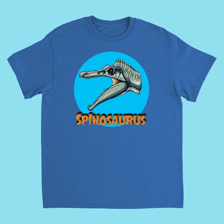 Jurassic Studio’s Kids Spinosaurus Head T-Shirt features an illustrated Spinosaurus head in a blue circle with bold orange SPINOSAURUS lettering—ideal for young dinosaur fans.