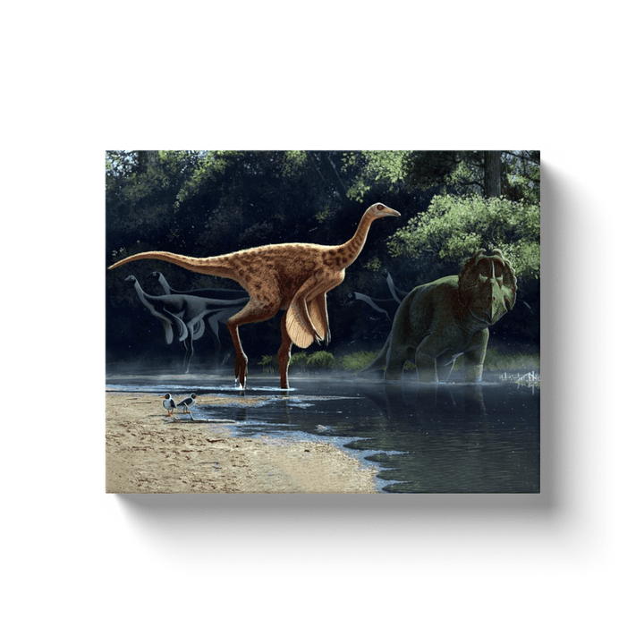 The Rativates Canvas Wrap by Jurassic Studio depicts a feathered dinosaur at the water’s edge, another dinosaur in the distance, lush forest, and two bird-like creatures—a vivid prehistoric wall art.