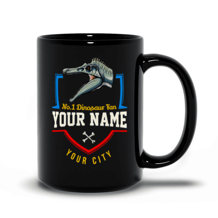 The N.1 Spinosaurus Fan Custom Mug by Jurassic Studio features a dinosaur head, No.1 Dinosaur fan text, crossed bones, and custom name/city fields—making it the perfect personalized gift for any dino lover.
