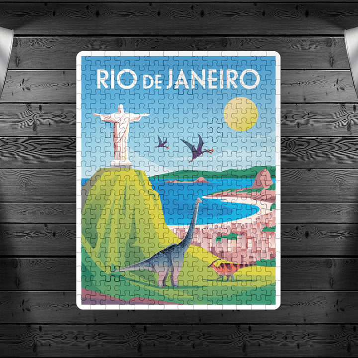 The Rio de Janeiro Puzzle by Jurassic Studio features Christ the Redeemer, mountains, beaches, dinosaurs, and pterosaurs under a sunny sky on a dark wooden background—a fun family indoor game.